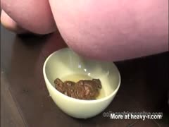 Busty MILF collects her shit using a small bowl